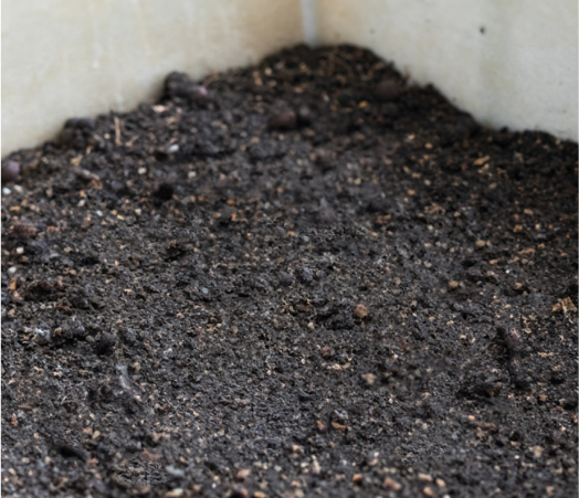 Decomposed faecal matter in the Aquatron bio-chamber — dark, hygienic compost ready to scoop out